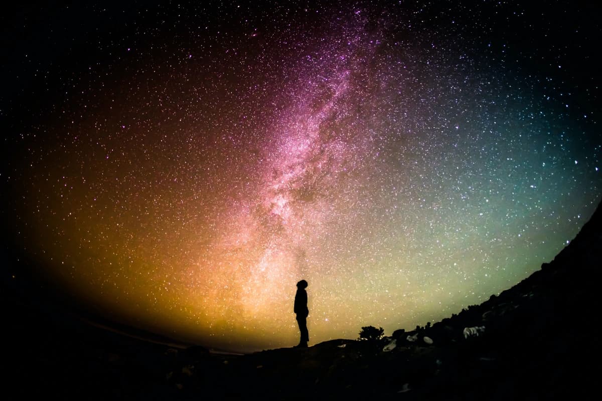 A person standing in front of a vibrant sky, symbolizing the creation of an ecosystem for ageless societies.