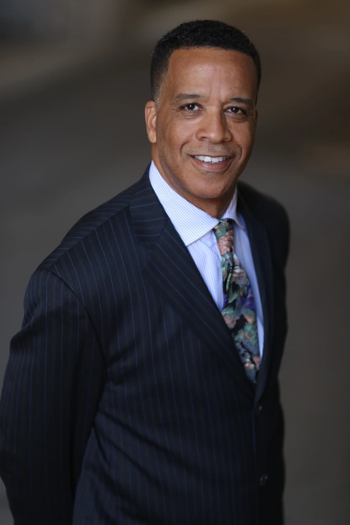  A professional black man in a suit and tie, radiating confidence and joy, representing Ageless Societies.